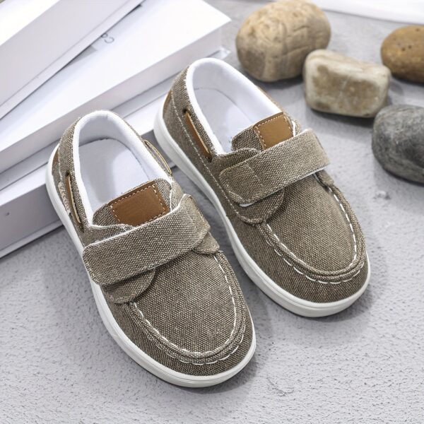Stylish and comfortable blue canvas shoes for boys, perfect for everyday wear. The shoes feature a classic design with a touch of modern style.