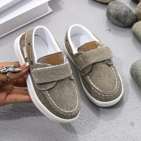 Stylish and comfortable blue canvas shoes for boys, perfect for everyday wear. The shoes feature a classic design with a touch of modern style.