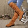 Newness Slouchy Knee High Boots in brown leather showcasing a chic and casual style perfect for winter The boots are slouchy and knee high highlighting their comfortable and fashionable design