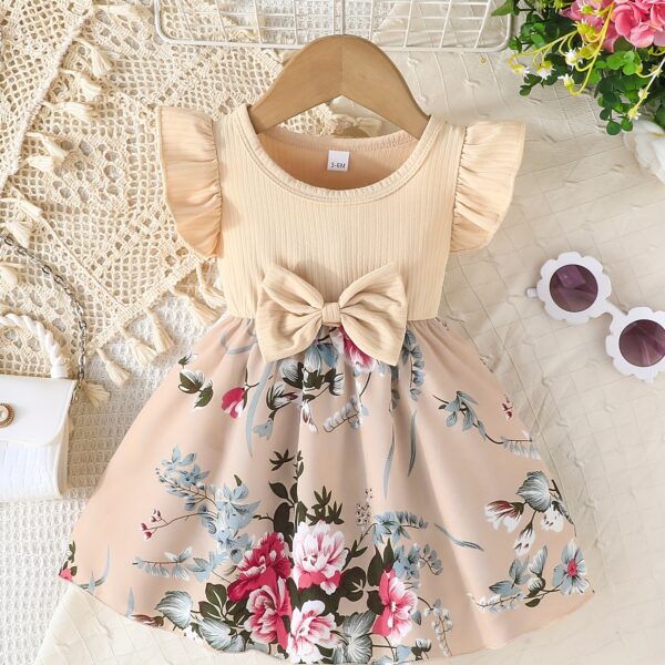 Adorable girl wearing a vibrant Summer Bloom floral print dress, perfect for summer. The dress features a playful, colorful floral pattern.