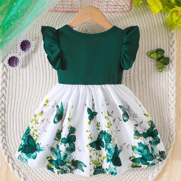 Adorable baby girl wearing a charming butterfly print dress from Newness, perfect for spring and summer.