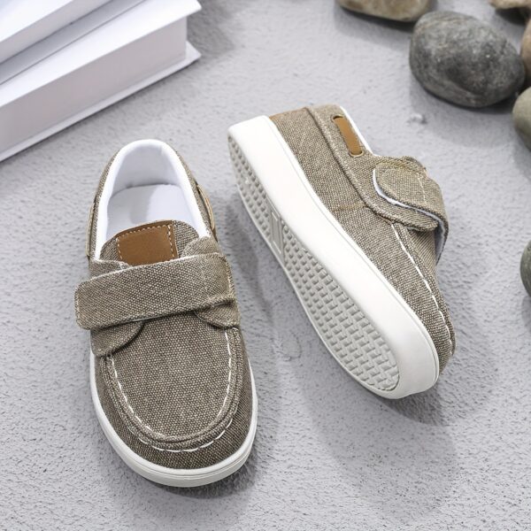 Stylish and comfortable blue canvas shoes for boys, perfect for everyday wear. The shoes feature a classic design with a touch of modern style.