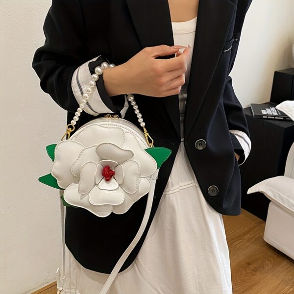 Camellia Blossom Floral Shoulder Bag from Newness, featuring a unique floral design, pearl accents, and an adjustable strap.