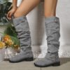 Newness Slouchy Knee High Boots in brown leather showcasing a chic and casual style perfect for winter The boots are slouchy and knee high highlighting their comfortable and fashionable design