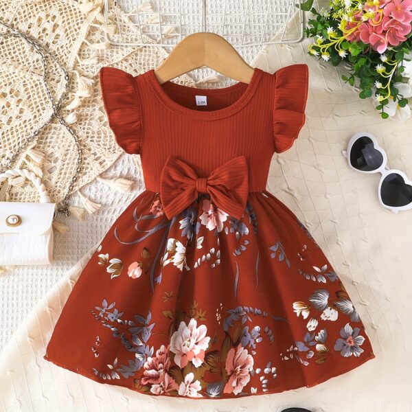 Adorable girl wearing a vibrant Summer Bloom floral print dress, perfect for summer. The dress features a playful, colorful floral pattern.