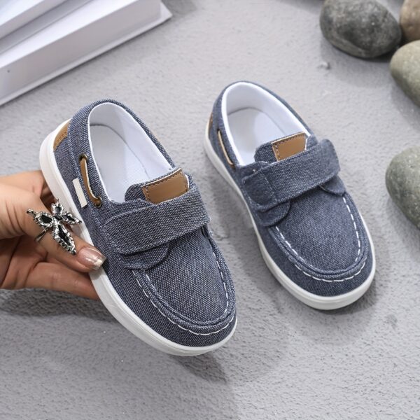 Stylish and comfortable blue canvas shoes for boys, perfect for everyday wear. The shoes feature a classic design with a touch of modern style.