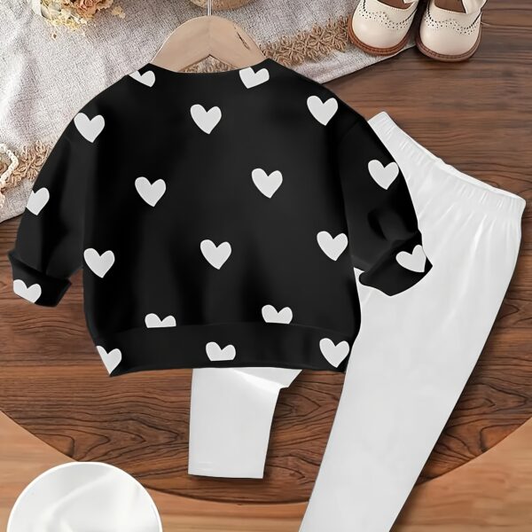 Adorable girls' playful set featuring a sweet heart print, perfect for fall and winter. The outfit includes [mention pieces included, e.g., a sweater and leggings] in soft, comfortable fabrics.
