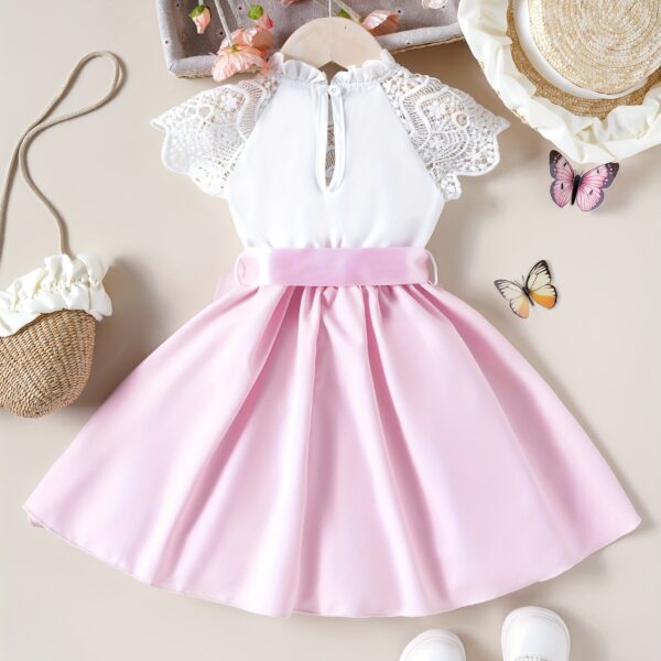 Adorable girl wearing a white Summer Bloom Lace Trim Dress, showcasing its delicate lace details and summery style.