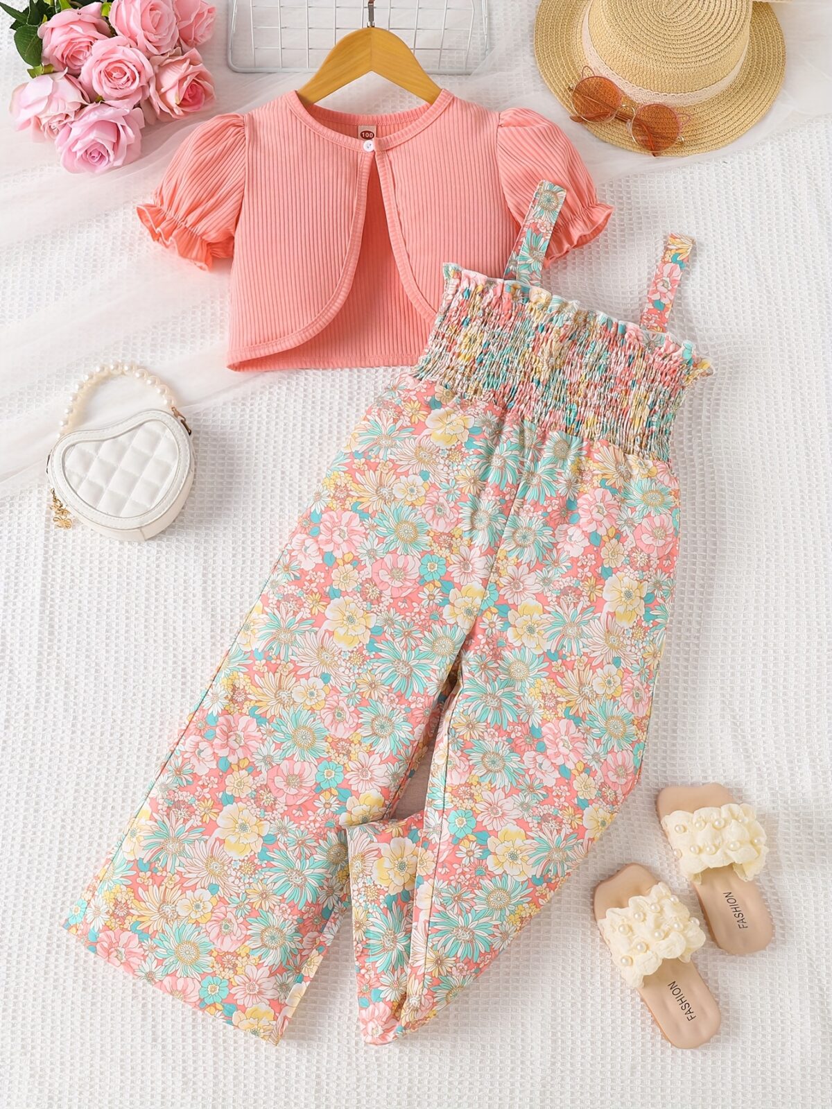 Adorable child wearing Newnesss Summer Bloom Floral Jumpsuit a boho chic floral jumpsuit perfect for sunny days
