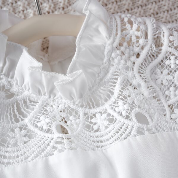 Adorable girl wearing a white Summer Bloom Lace Trim Dress, showcasing its delicate lace details and summery style.