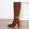 Newnesss commanding chunky heel knee high boots in brown leather showcasing the side profile and heel