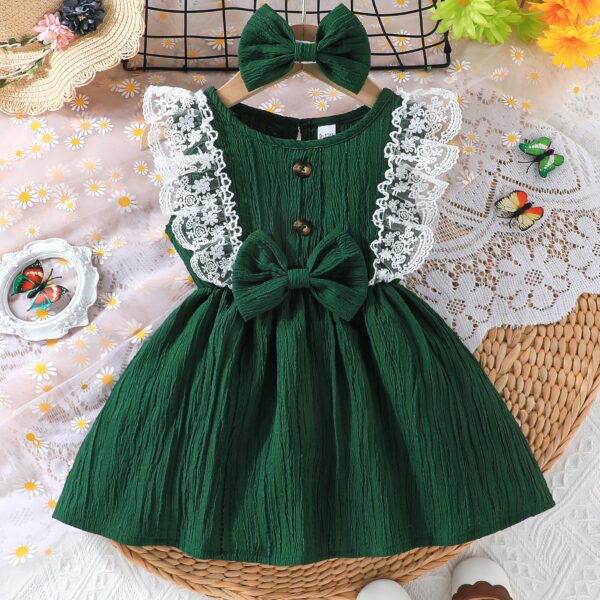 Toddler girl wearing a charming emerald green summer dress, ideal for playing outdoors.