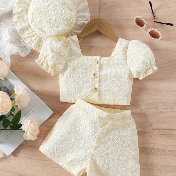 Adorable baby girl wearing a Summer Bloom floral outfit, perfect for summer. The outfit features a delightful floral pattern.
