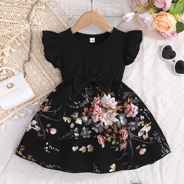Adorable girl wearing a vibrant Summer Bloom floral print dress, perfect for summer. The dress features a playful, colorful floral pattern.