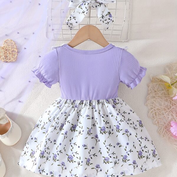 Adorable baby girl wearing a lightweight Summer Meadow floral print dress, perfect for casual summer outings.