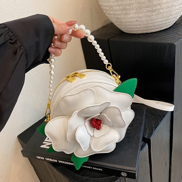 Camellia Blossom Floral Shoulder Bag from Newness, featuring a unique floral design, pearl accents, and an adjustable strap.