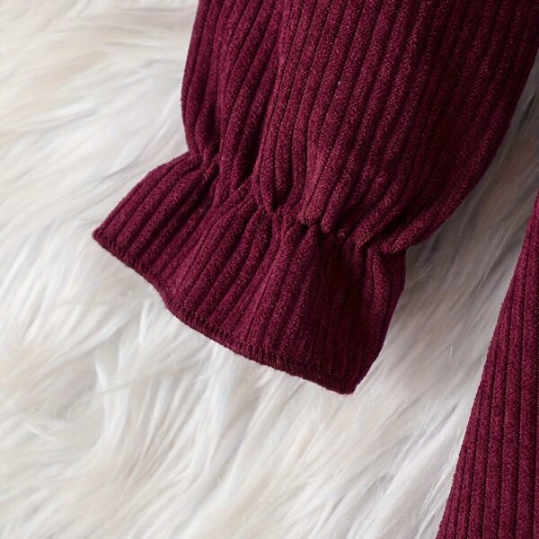 Adorable baby girl wearing a charming corduroy dress, perfect for playtime or special occasions.