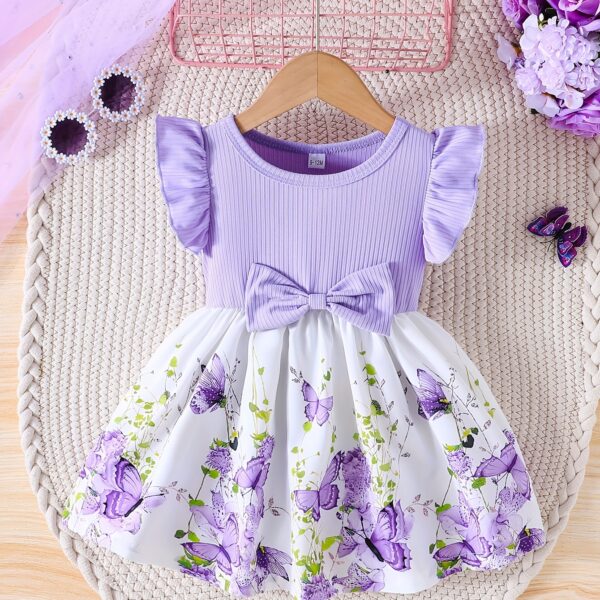 Adorable baby girl wearing a charming butterfly print dress from Newness, perfect for spring and summer.