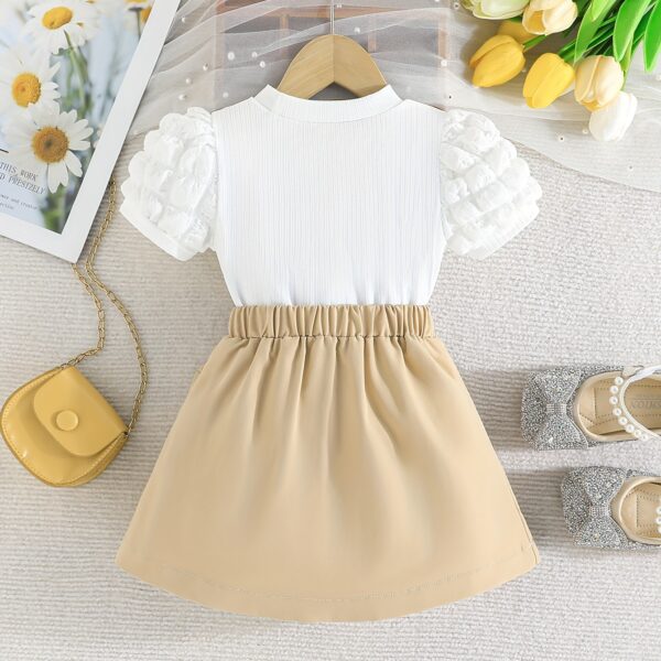 Adorable Pastel Dream Girls' Summer Set featuring a pastel-colored top and bottom, perfect for summer. The outfit is shown on a young girl, highlighting its comfortable and stylish design.