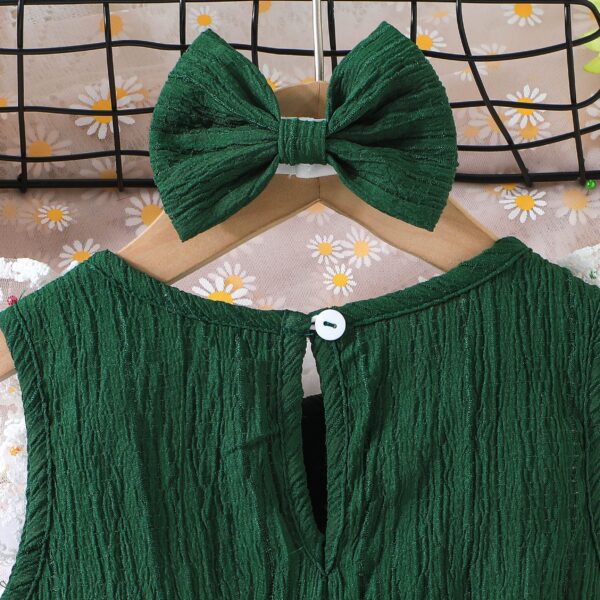Toddler girl wearing a charming emerald green summer dress, ideal for playing outdoors.