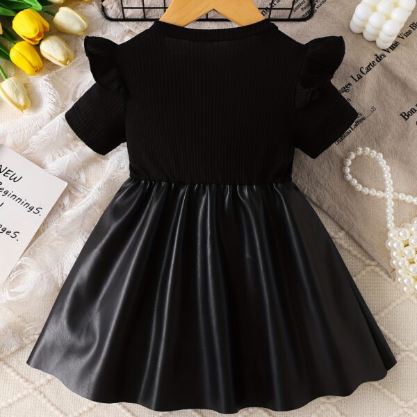 Adorable baby girl wearing a charming Little Darling Baby Bow Dress, perfect for parties or playdates. The dress features a beautiful bow detail.