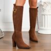 Newnesss commanding chunky heel knee high boots in brown leather showcasing the side profile and heel