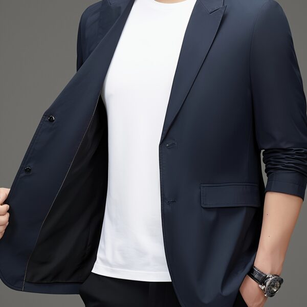 Newness Metropolitan Men's Casual Suit Jacket in versatile navy blue, modeled on a man striding confidently through a city street. The jacket is shown to highlight its sophisticated style and comfortable fit, perfect for spring or autumn.