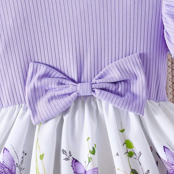 Adorable baby girl wearing a charming butterfly print dress from Newness, perfect for spring and summer.
