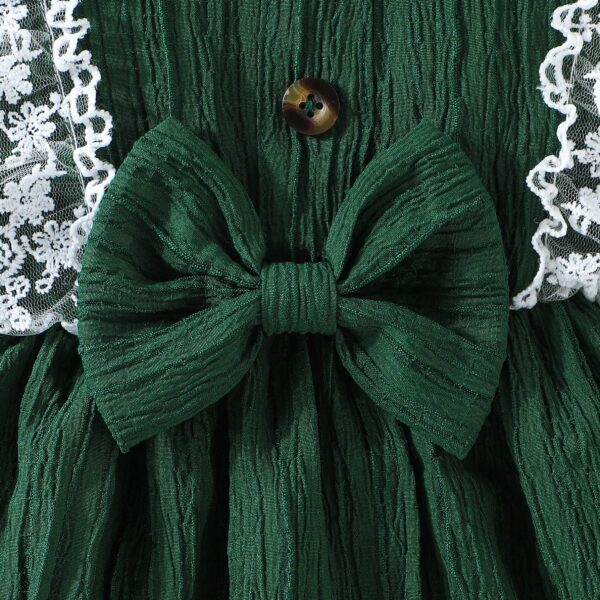 Toddler girl wearing a charming emerald green summer dress, ideal for playing outdoors.