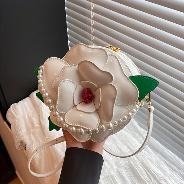 Camellia Blossom Floral Shoulder Bag from Newness, featuring a unique floral design, pearl accents, and an adjustable strap.