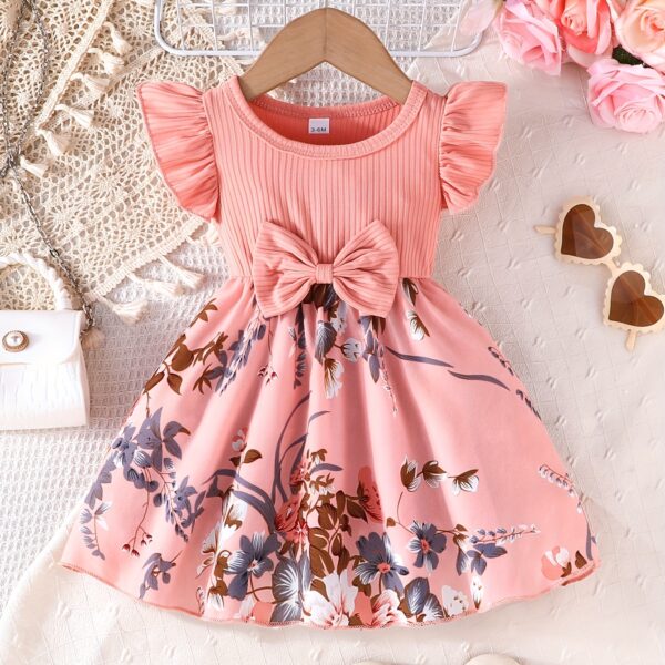 Adorable girl wearing a vibrant Summer Bloom floral print dress, perfect for summer. The dress features a playful, colorful floral pattern.