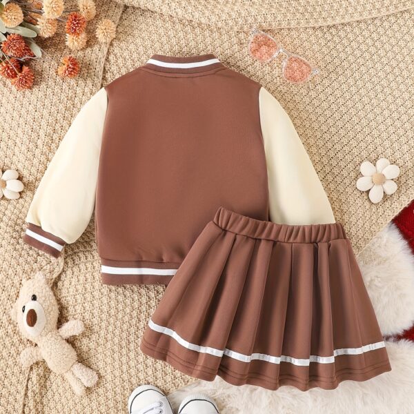 Stylish girls' preppy patchwork baseball jacket and skirt set, perfect for fall and winter. Features a mix of colorful patches on a comfortable jacket and matching skirt.