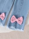 Adorable toddler girl in a stylish summer outfit featuring a cute bow Shop Newness for more childrens fashion