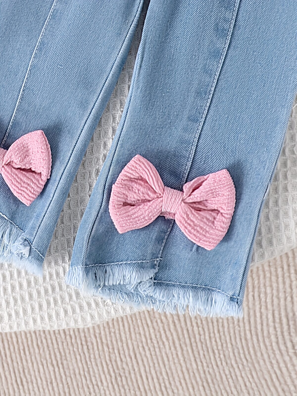 Adorable toddler girl in a stylish summer outfit featuring a cute bow Shop Newness for more childrens fashion