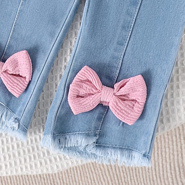 Adorable toddler girl in a stylish summer outfit, featuring a cute bow. Shop Newness for more children's fashion.