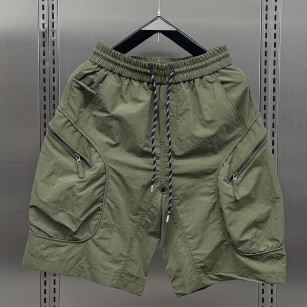 Model wearing Newness Tactical Camo Cargo Shorts, showcasing their loose fit and camo pattern. Ideal for summer adventures.