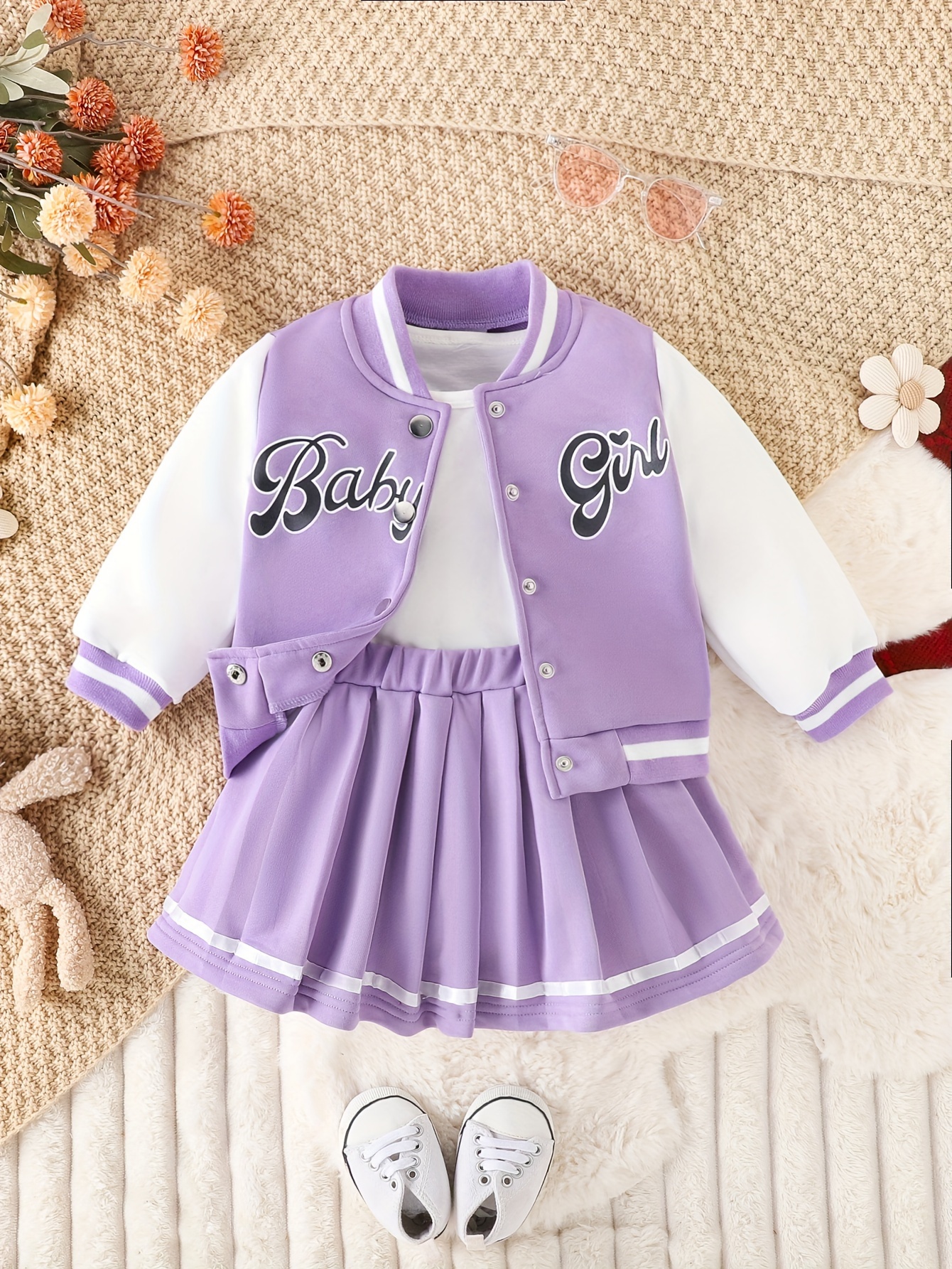 Stylish girls' preppy patchwork baseball jacket and skirt set, perfect for fall and winter. Features a mix of colorful patches on a comfortable jacket and matching skirt.