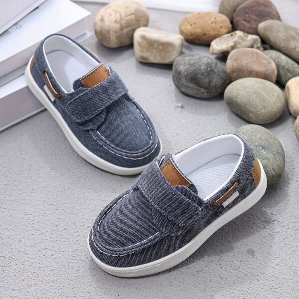 Stylish and comfortable blue canvas shoes for boys, perfect for everyday wear. The shoes feature a classic design with a touch of modern style.