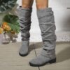 Newness Slouchy Knee High Boots in brown leather showcasing a chic and casual style perfect for winter The boots are slouchy and knee high highlighting their comfortable and fashionable design
