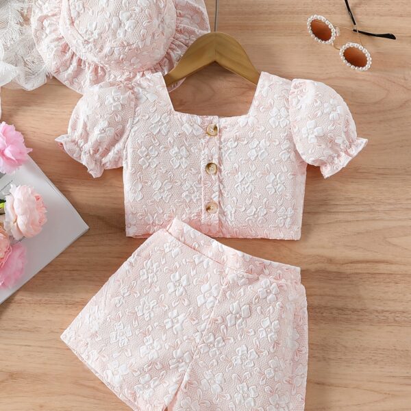 Adorable baby girl wearing a Summer Bloom floral outfit, perfect for summer. The outfit features a delightful floral pattern.