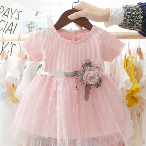 Adorable little girl twirling in a pink Summer Bloom Rose Princess Dress from Newness, showcasing its comfortable and stylish design.