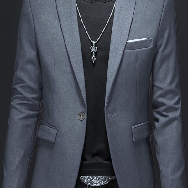 The Newness City Slicker Slim Fit Blazer: A sophisticated navy blazer in a slim fit, ideal for the modern man. Shown on a model in a stylish setting.