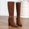 Newnesss commanding chunky heel knee high boots in brown leather showcasing the side profile and heel