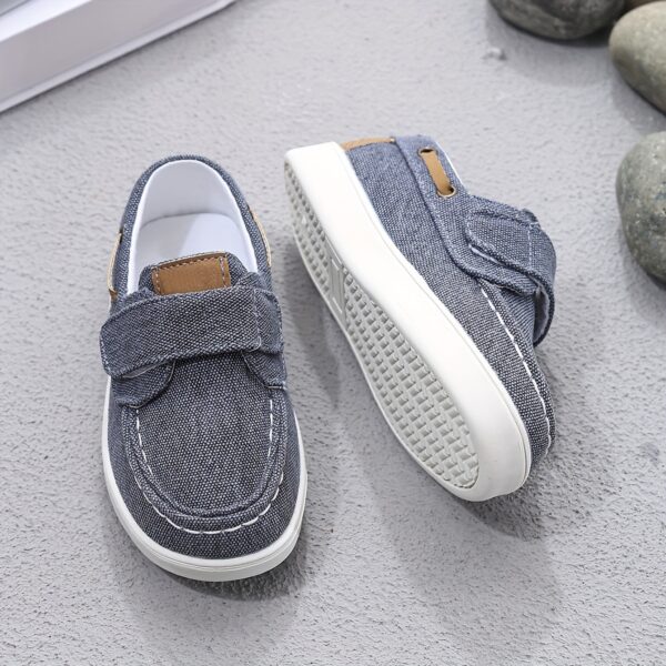 Stylish and comfortable blue canvas shoes for boys, perfect for everyday wear. The shoes feature a classic design with a touch of modern style.