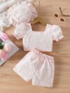 Adorable baby girl wearing a Summer Bloom floral outfit perfect for summer The outfit features a delightful floral pattern