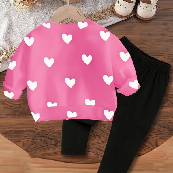 Adorable girls' playful set featuring a sweet heart print, perfect for fall and winter. The outfit includes [mention pieces included, e.g., a sweater and leggings] in soft, comfortable fabrics.