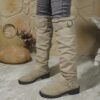 Newness Slouchy Knee High Boots in brown leather showcasing a chic and casual style perfect for winter The boots are slouchy and knee high highlighting their comfortable and fashionable design