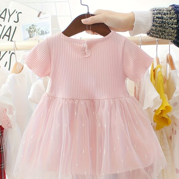 Adorable little girl twirling in a pink Summer Bloom Rose Princess Dress from Newness, showcasing its comfortable and stylish design.