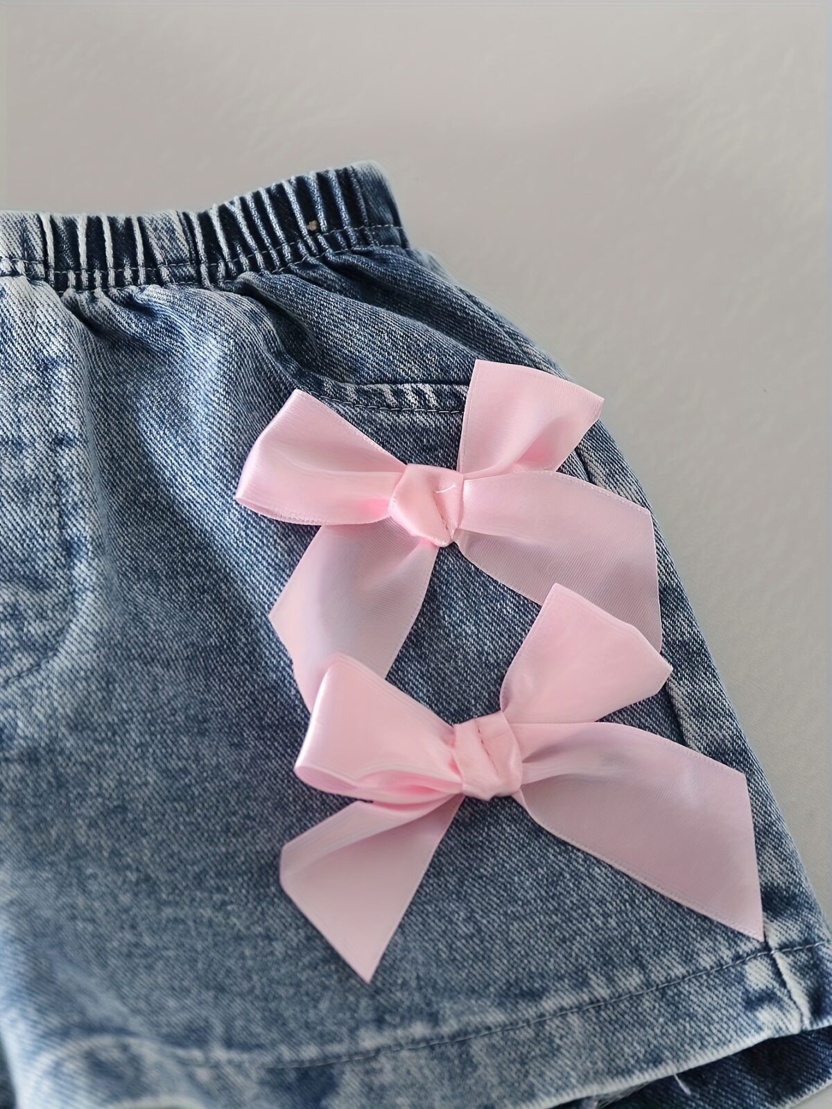 Adorable girls denim set with sweetheart neckline and bow detail perfect for playdates or school