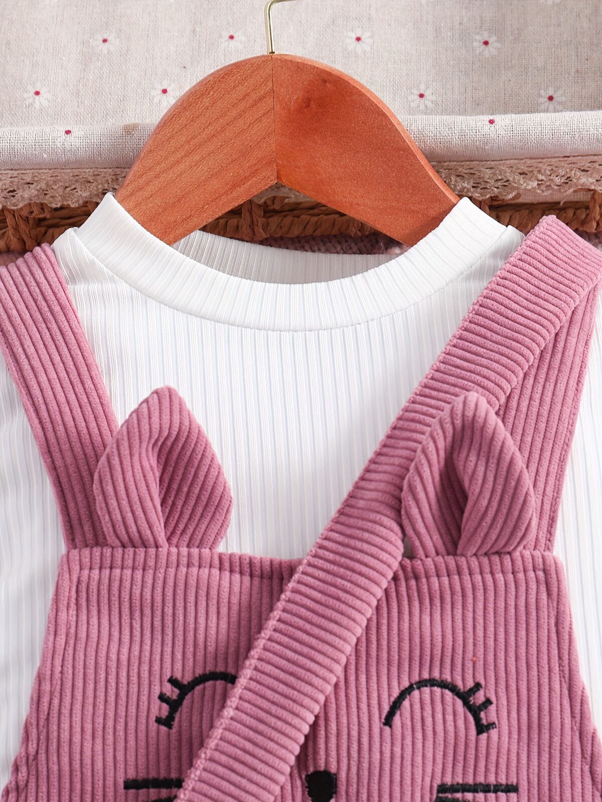 Adorable little girl wearing a playful cat embroidered jumpsuit perfect for spring or autumn The jumpsuit is comfortable and stylish